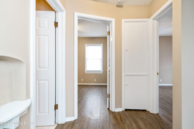 hallway with hardwood / wood-style flooring and a textured ceiling