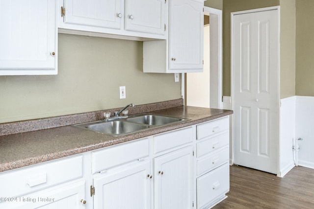 kitchen with white cabinets, dark hardwood / wood-style floors, and sink