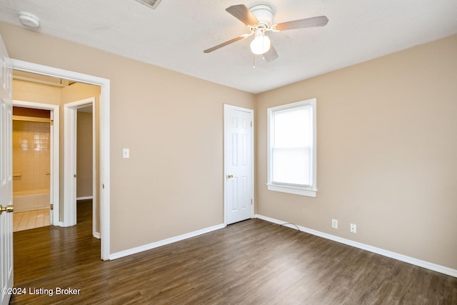 unfurnished bedroom featuring a textured ceiling, ceiling fan, and dark wood-type flooring