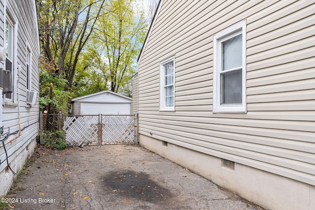 view of home's exterior with cooling unit and an outdoor structure