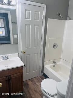 full bathroom with bathing tub / shower combination, vanity, wood-type flooring, and toilet