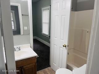 full bathroom featuring shower / tub combination, vanity, and toilet