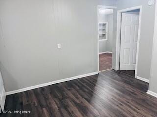 empty room with dark hardwood / wood-style floors