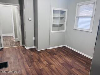 empty room featuring dark wood-type flooring