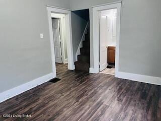 spare room with dark hardwood / wood-style flooring