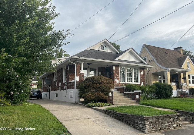 bungalow-style home featuring a front lawn