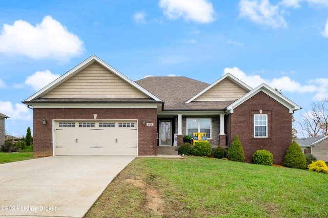 craftsman inspired home featuring a garage and a front lawn