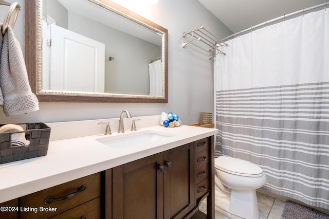 bathroom with tile patterned flooring, vanity, and toilet