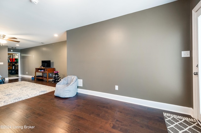 interior space with ceiling fan and dark wood-type flooring