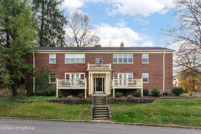 view of front of property with a front yard and a deck