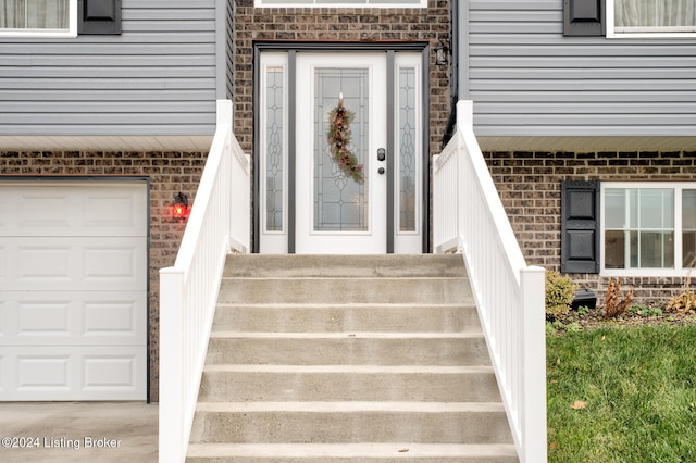 view of exterior entry with a garage