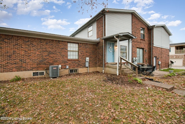 back of property featuring central AC unit