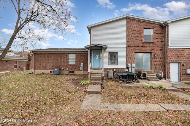 rear view of property featuring a patio area and central AC