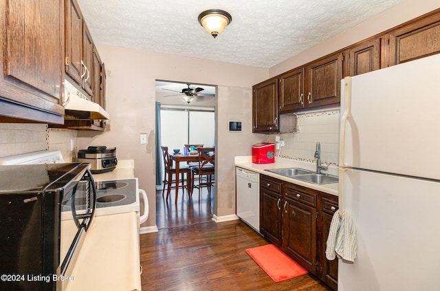 kitchen featuring white appliances, backsplash, sink, ceiling fan, and dark hardwood / wood-style flooring