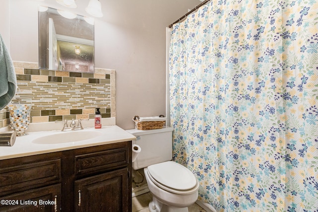 bathroom with decorative backsplash, toilet, and vanity