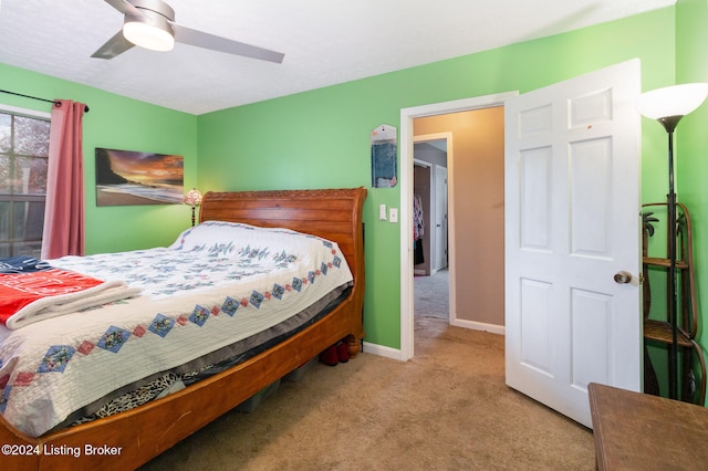 bedroom featuring light colored carpet and ceiling fan