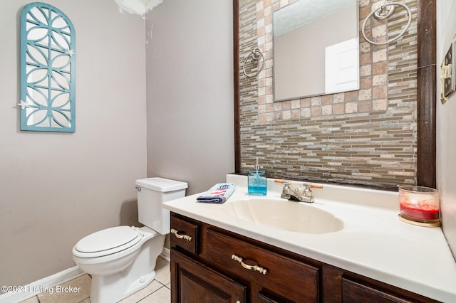 bathroom featuring tile patterned flooring, vanity, toilet, and tasteful backsplash