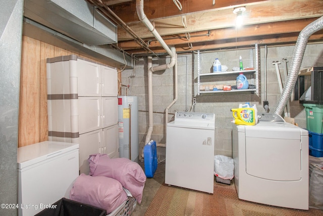 clothes washing area with washing machine and dryer and water heater