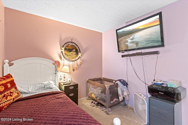 bedroom with carpet and a textured ceiling