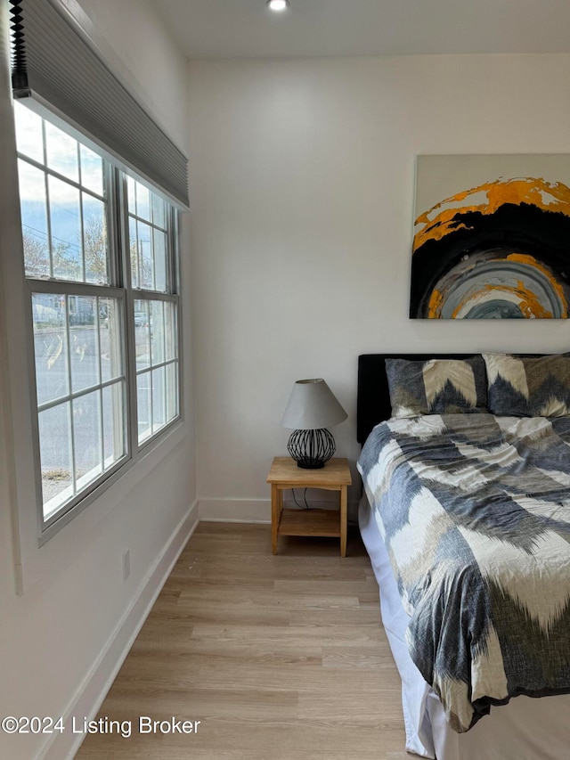 bedroom with light wood-style flooring, baseboards, and recessed lighting