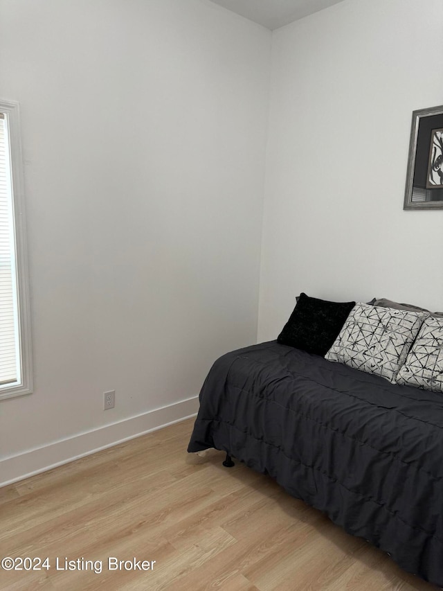 bedroom featuring light wood-type flooring and baseboards