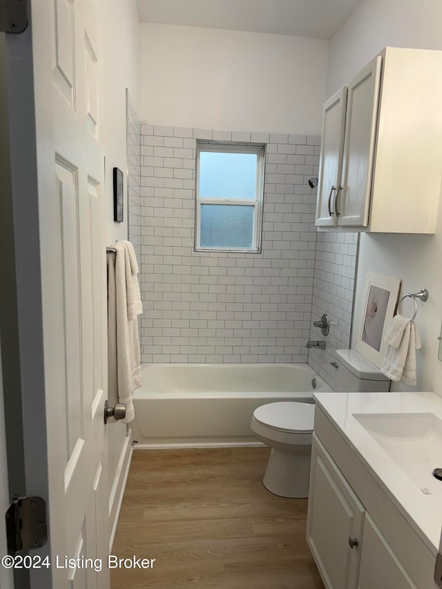 full bathroom featuring bathtub / shower combination, vanity, toilet, and wood finished floors