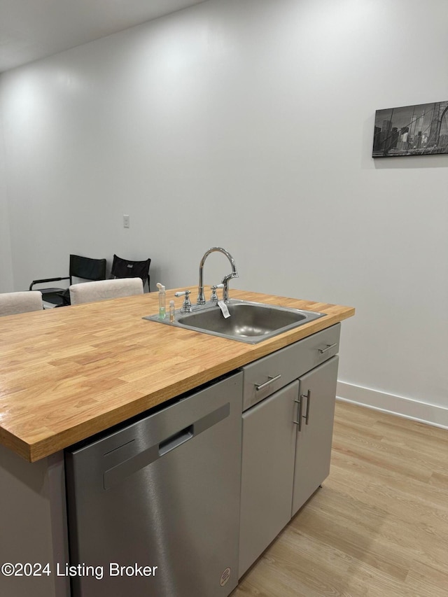 kitchen featuring gray cabinets, dishwasher, light hardwood / wood-style floors, and sink