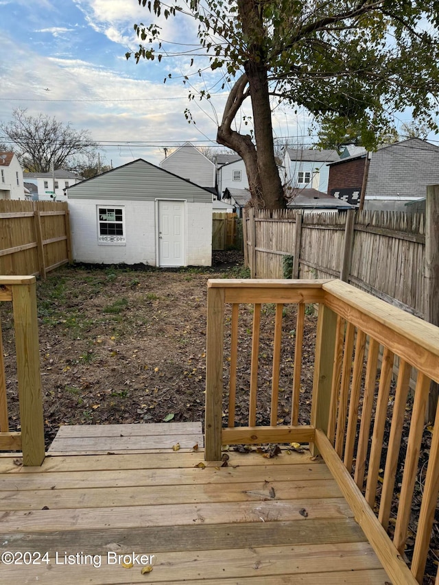 deck featuring an outbuilding and a fenced backyard