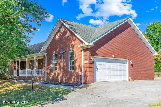 view of side of home featuring covered porch