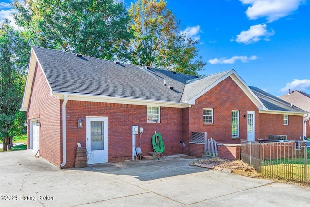 back of property with a garage