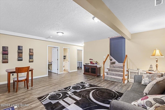 living room featuring hardwood / wood-style floors and a textured ceiling