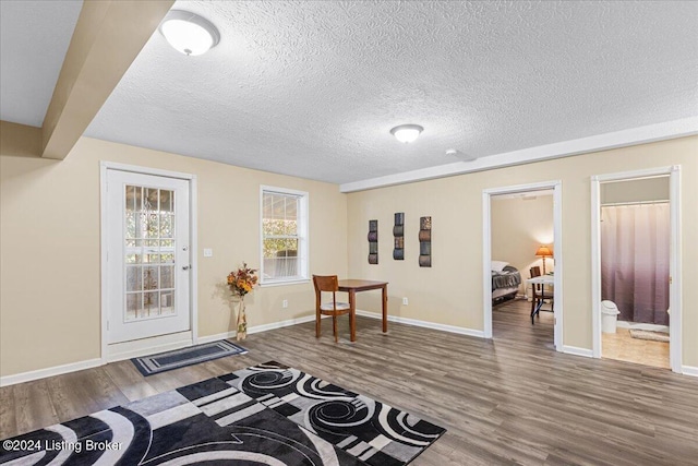 interior space with wood-type flooring and a textured ceiling