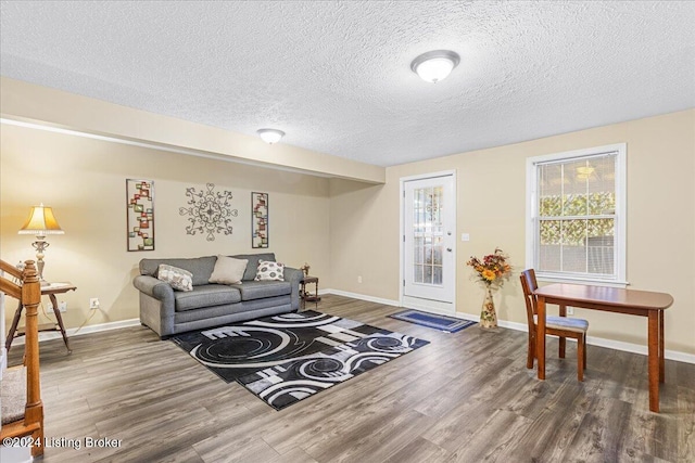 living room with a textured ceiling and hardwood / wood-style flooring