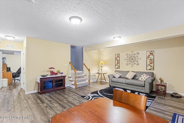 living room with hardwood / wood-style floors and a textured ceiling