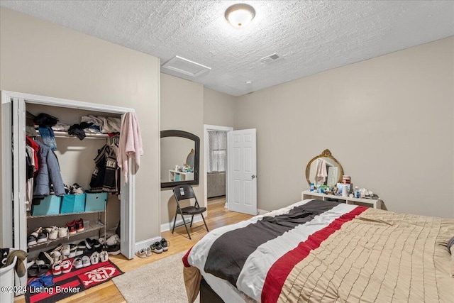 bedroom featuring a textured ceiling and hardwood / wood-style flooring