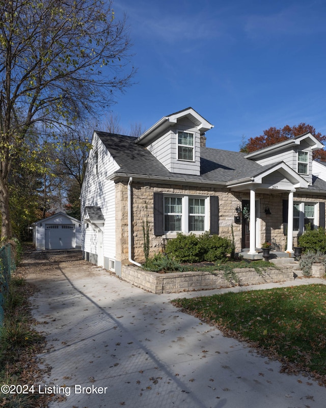 view of front of home with a garage and an outdoor structure