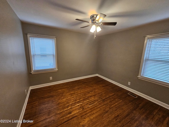 empty room featuring ceiling fan and dark hardwood / wood-style floors