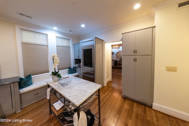 kitchen with hardwood / wood-style floors and ornamental molding