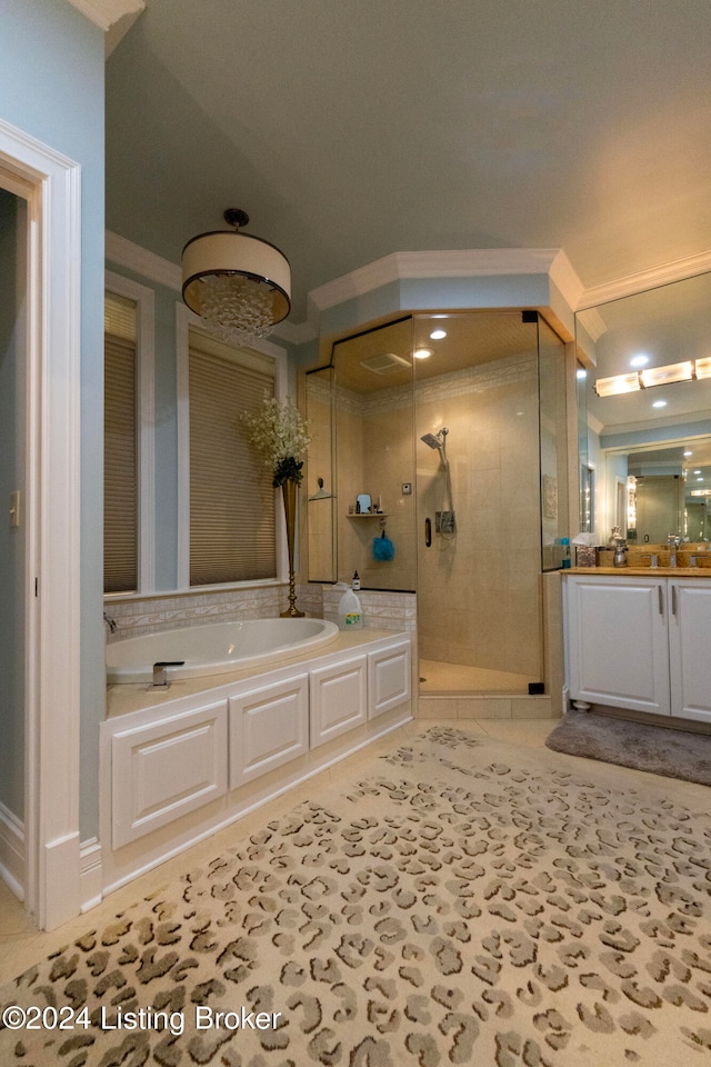 bathroom with tile patterned flooring, vanity, and separate shower and tub