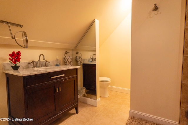 bathroom with tile patterned flooring, vanity, and toilet