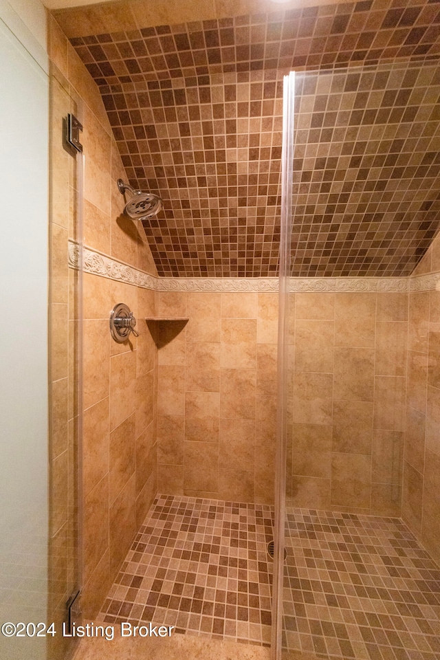 bathroom featuring a shower with shower door