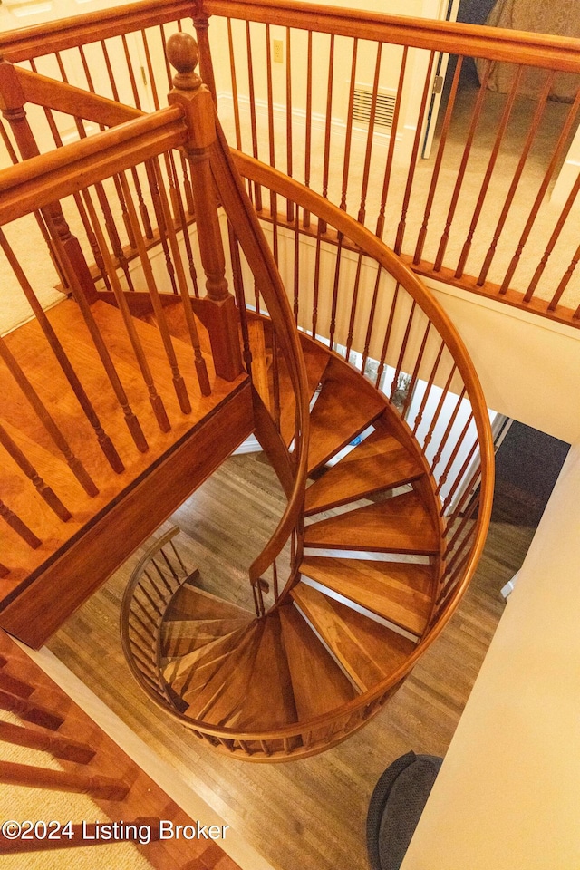 stairway with hardwood / wood-style floors