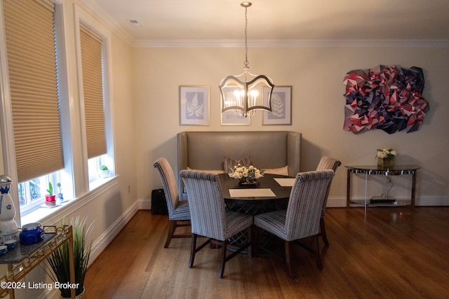 dining room featuring a chandelier, crown molding, and dark wood-type flooring