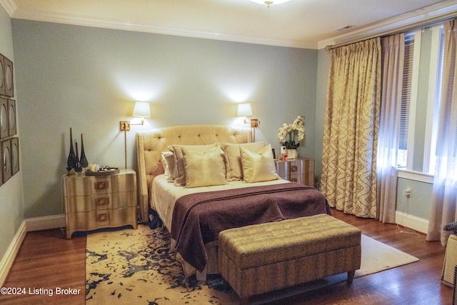 bedroom with dark hardwood / wood-style floors and ornamental molding