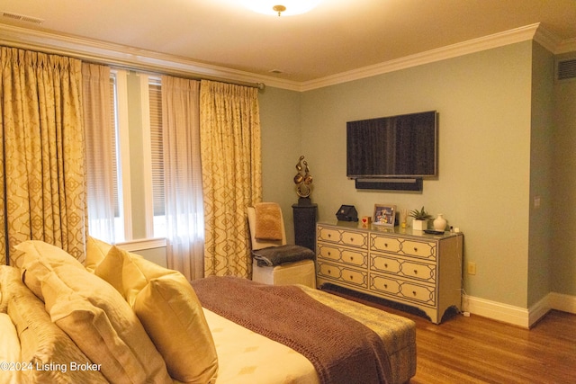 bedroom with hardwood / wood-style flooring and ornamental molding