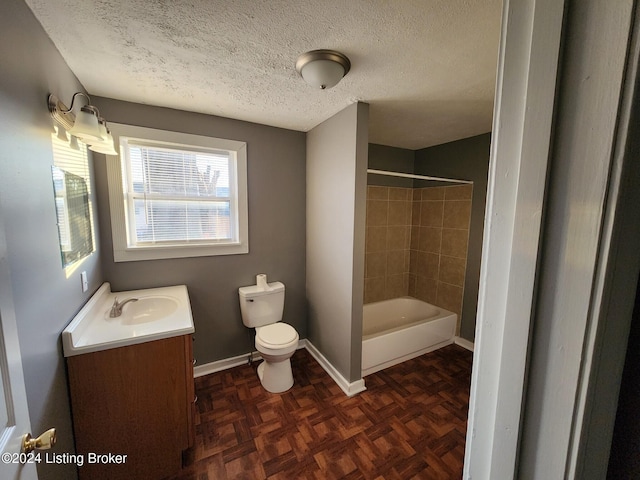 full bathroom with parquet flooring, a textured ceiling, toilet, vanity, and tiled shower / bath