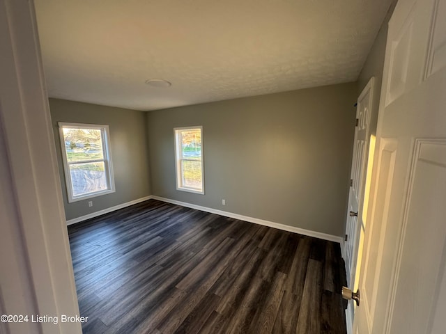 empty room with dark hardwood / wood-style floors