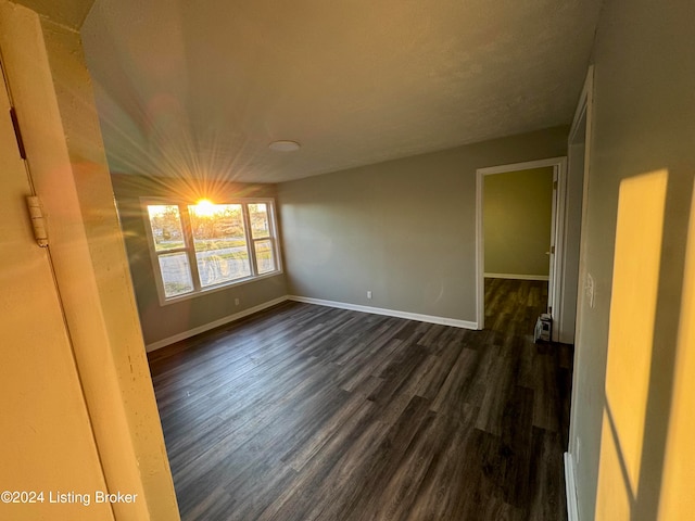 empty room with dark hardwood / wood-style floors