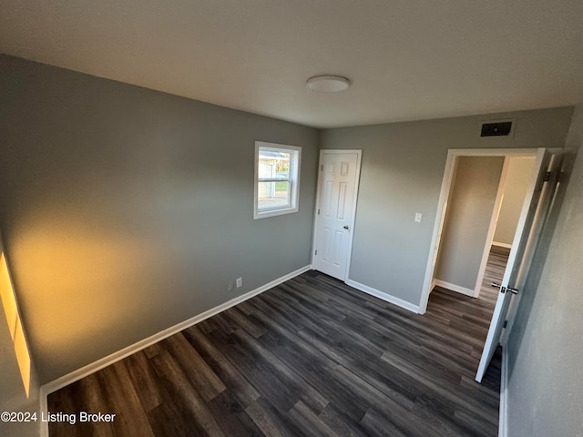 unfurnished bedroom featuring dark wood-type flooring