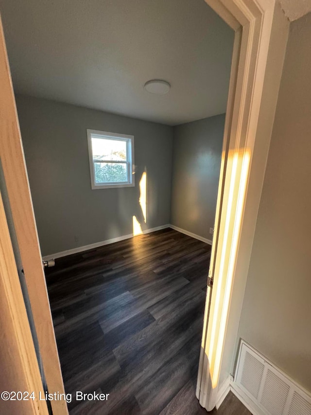 unfurnished room featuring dark hardwood / wood-style flooring